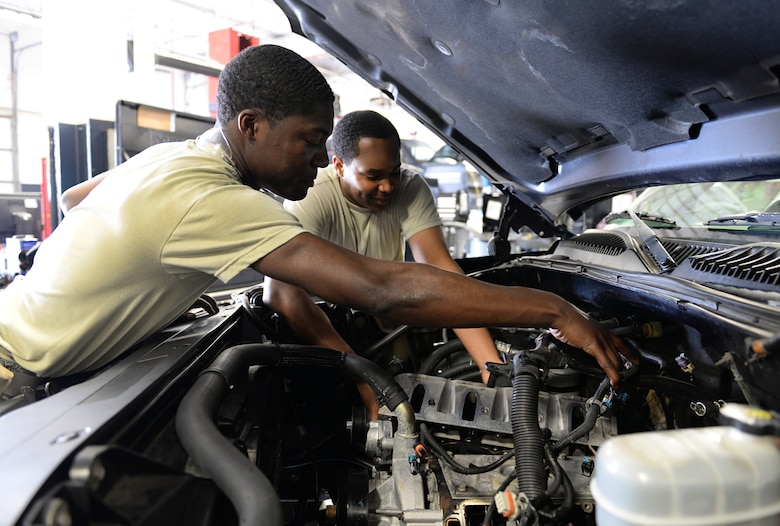 Airman Claude Milsap III and Senior Airman Kenneth Carter, 81st Logistics Readiness Squadron vehicle maintenance technicians, repair a security forces truck March 11, 2015, Keesler Air Force Base, Miss. The more than 40 member vehicle maintenance flight repair and oversee more than 420 government vehicles that belong to Keesler. (U.S. Air Force photo by Senior Airman Holly Mansfield)