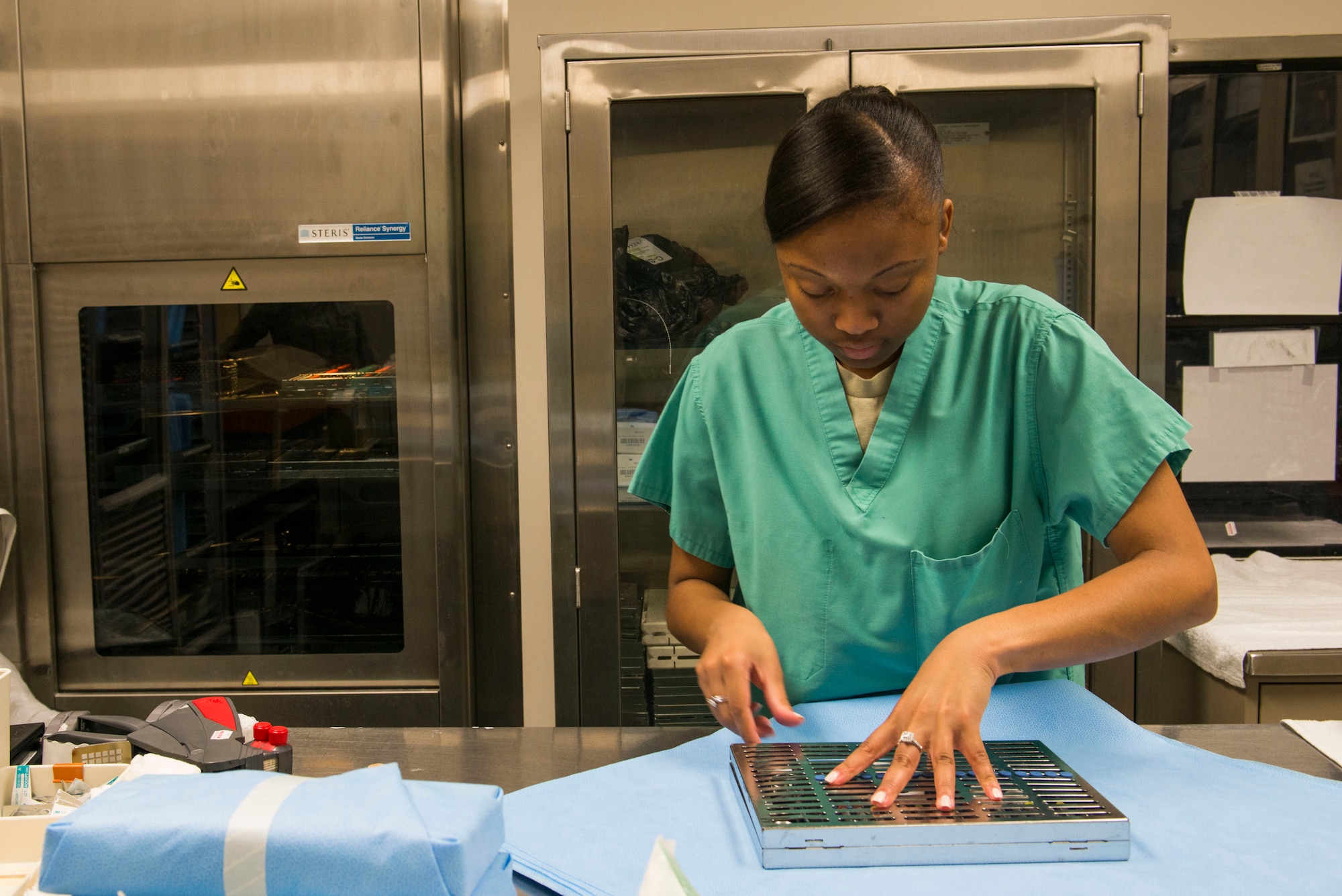 U.S. Air Force Airman 1st Class Candice Bates, 23d Aerospace Medicine Squadron dental assistant, inspects dental instruments before sterilization March 12, 2015, at Moody Air Force Base, Ga. Dental clinic personnel are required to sterilize their equipment to prevent infections and contamination with patients. (U.S. Air Force photo by Airman 1st Class Dillian Bamman/Released)