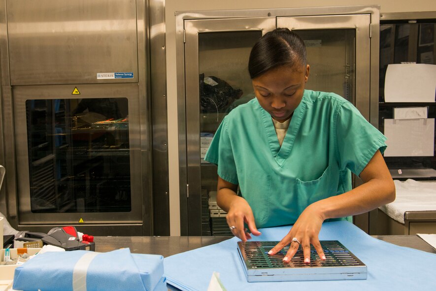 U.S. Air Force Airman 1st Class Candice Bates, 23d Aerospace Medicine Squadron dental assistant, inspects dental instruments before sterilization March 12, 2015, at Moody Air Force Base, Ga. Dental clinic personnel are required to sterilize their equipment to prevent infections and contamination with patients. (U.S. Air Force photo by Airman 1st Class Dillian Bamman/Released)
