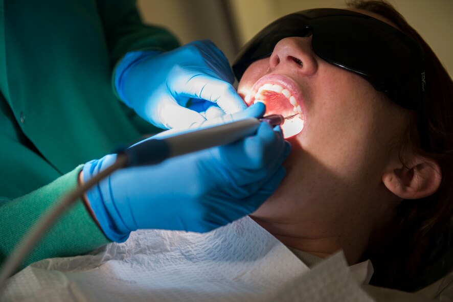 A 23d Aerospace Medicine Squadron dental assistant cleans a patient’s teeth during an annual dental cleaning March 12, 2015, at Moody Air Force Base, Ga. This week was Patient Safety Week for the dental clinic during which medical personnel focused on better patient satisfaction with surveys for their visit. (U.S. Air Force photo by Airman 1st Class Dillian Bamman/Released)