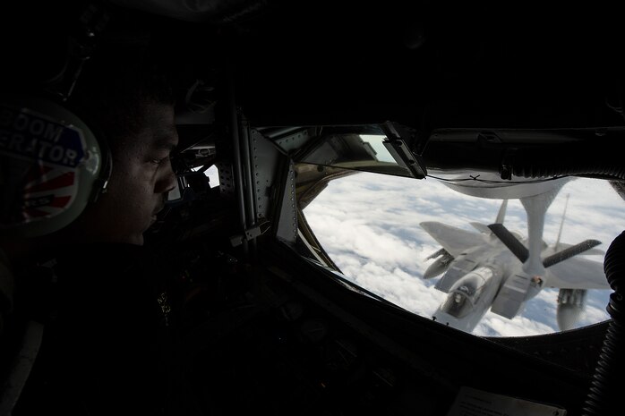 U.S. Air Force Airman 1st Class Cory Drummond Jr. a 909th Aerial Refueling Squadron boom operator, refuels a F-15 Eagle from the 67th Fighter Squadron, during an exercise sortie flown at Cope North 15, Feb. 20, 2015, off the coast of Guam. Through training exercises such as Exercise Cope North 15, the U.S., Japan and Australia air forces develop combat capabilities, enhancing air superiority, electronic warfare, air interdiction, tactical airlift and aerial refueling. (U.S. Air Force photo by Tech. Sgt. Jason Robertson/Released)