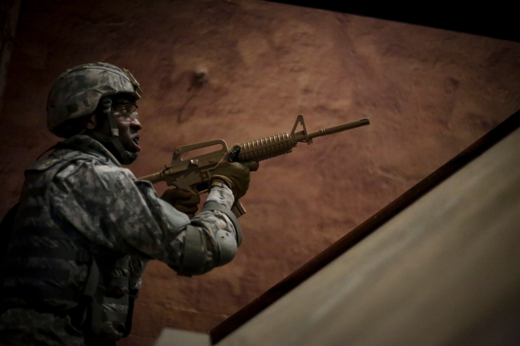 U.S. Army Master Sgt. Alvin Fields clears a doorway during a Modern Army Combatives Program (MACP) training scenario at the New Jersey National Guard Training and Training Technology Battle Lab at Joint Base McGuire-Dix-Lakehurst, N.J., March 11, 2015. The Battle Lab features numerous combat simulators, as well as an indoor urban area for ground combat training. Fields is assigned to the 1-314th Infantry Battalion. (U.S. Air National Guard photo by Tech. Sgt. Matt Hecht/Released)