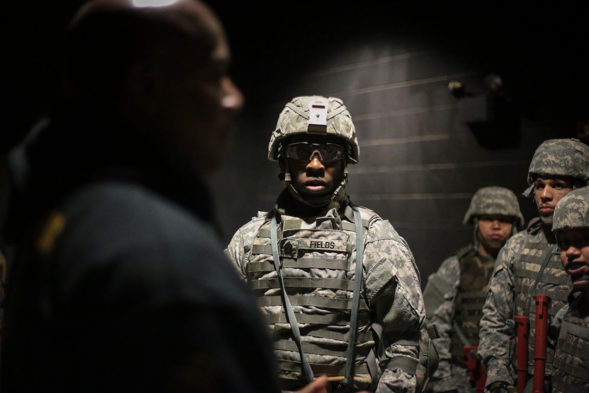 U.S. Army Soldiers listen to Modern Army Combatives Program (MACP) instructor Master Sgt. Raymond Olson prior to a training scenario at the New Jersey National Guard Training and Training Technology Battle Lab at Joint Base McGuire-Dix-Lakehurst, N.J., March 11, 2015. The Battle Lab features numerous combat simulators, as well as an indoor urban area for ground combat training. (U.S. Air National Guard photo by Tech. Sgt. Matt Hecht/Released)