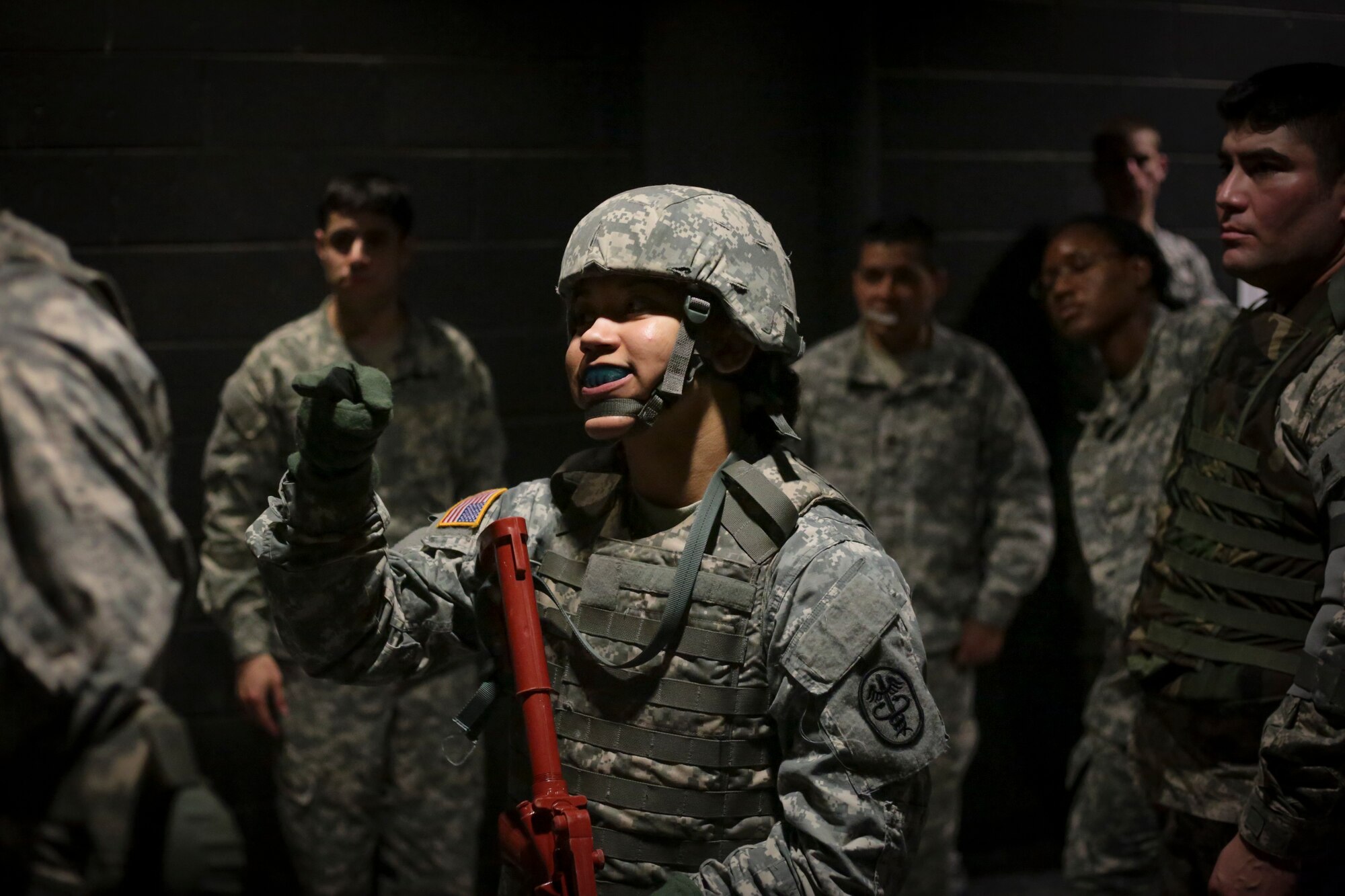 U.S. Army Spc. Rosa Rivera listens to a briefing on Modern Army Combatives Program (MACP) prior to a training scenario at the New Jersey National Guard Training and Training Technology Battle Lab at Joint Base McGuire-Dix-Lakehurst, N.J., March 11, 2015. The Battle Lab features numerous combat simulators, as well as an indoor urban area for ground combat training. Rivera is assigned to the 7236th Medical Support Unit. (U.S. Air National Guard photo by Tech. Sgt. Matt Hecht/Released)