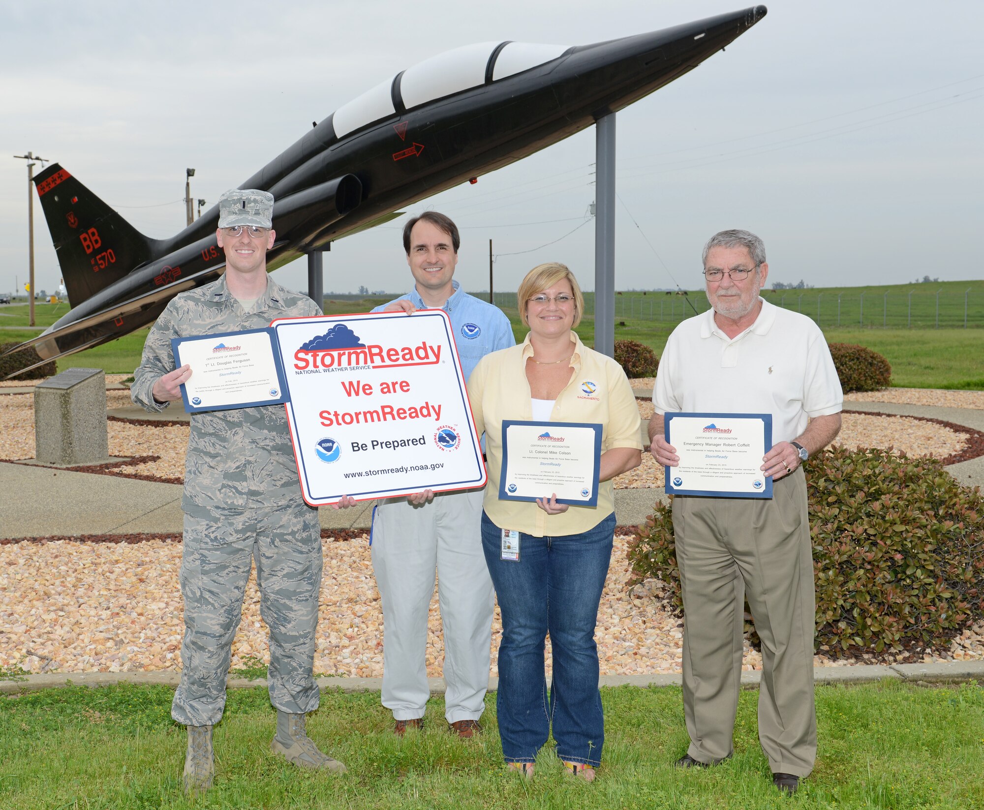 The National Weather Service Sacramento Office presents members of the 9th Operations Support Squadron weather flight a sign and certificates after certifying to be a StormReady community March 10, 2015, at Beale Air Force Base, Calif. StormReady is a program created by the NWS to ensure that communities have the communication and safety skills needed to save lives and property at all stages of a severe weather event. (U.S. Air Force photo by John Schwab/Released)