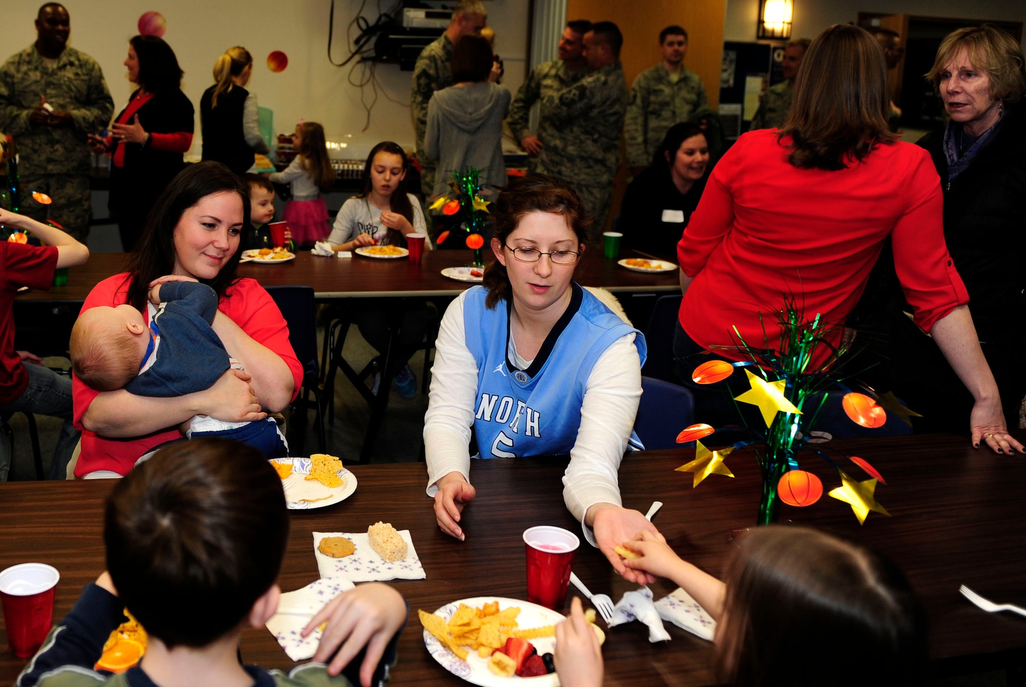 Team Mildenhall families of deployed Airmen gather for dinner during the monthly Hearts Apart event, March 12, 2015, at the chapel on RAF Mildenhall, England. A Hearts Apart dinner is an opportunity for spouses and family members of deployed Airmen to gather and show support for one another. (U.S. Air Force photo/Staff Sgt. Krystie Martinez/Released)