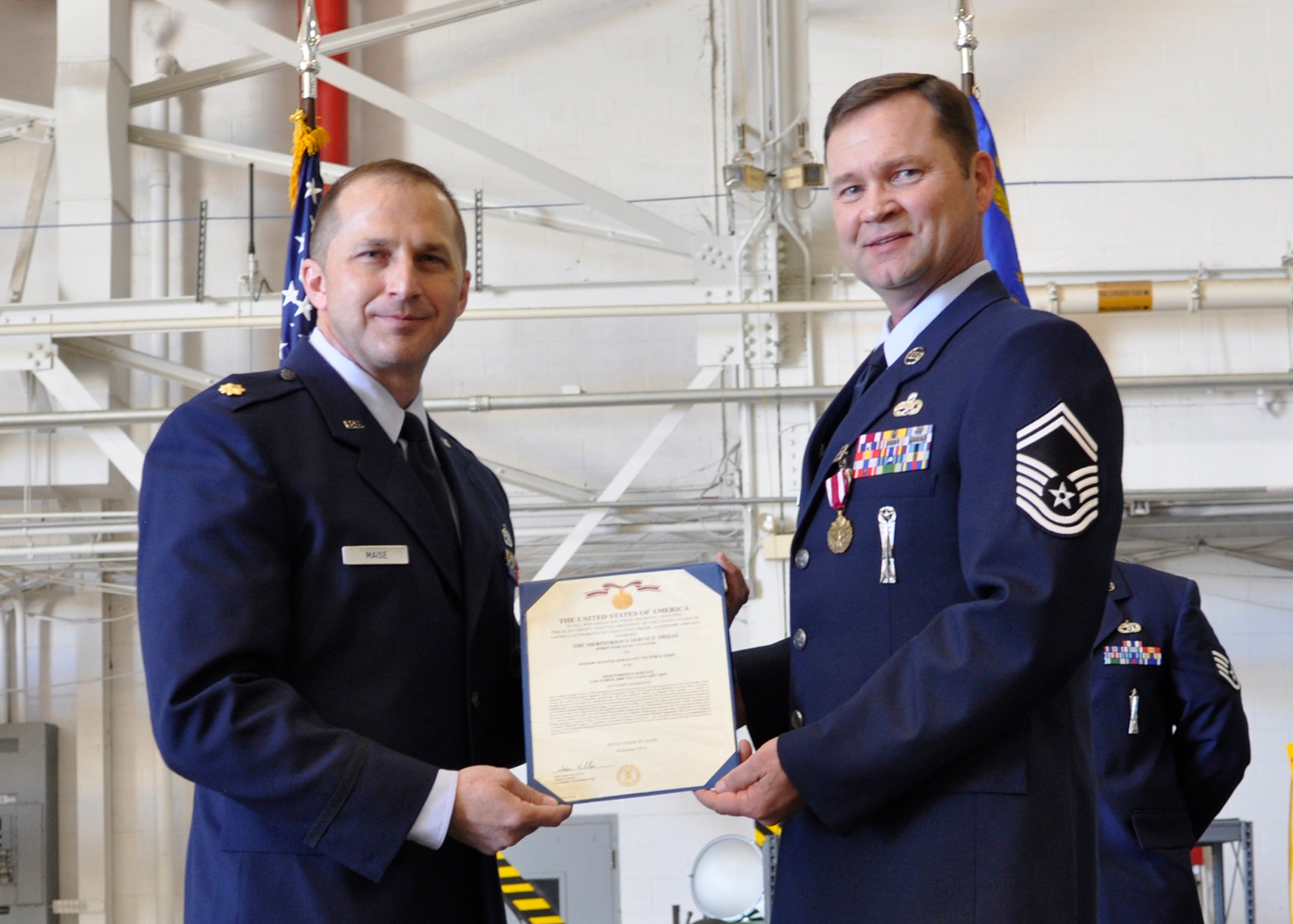 U.S. Air Force Senior Master Sgt. Victor Goff is awarded the Air Force Meritorious Service Medal during his retirement ceremony, Mar.  7, 2015, Barksdale Air Force Base, La. Goff received the award for distinguished service as the Armament Shop Chief for the 307th Maintenance Squadron. (U.S. Air Force photo by 2nd Lieutenant Monique Roux/Released)