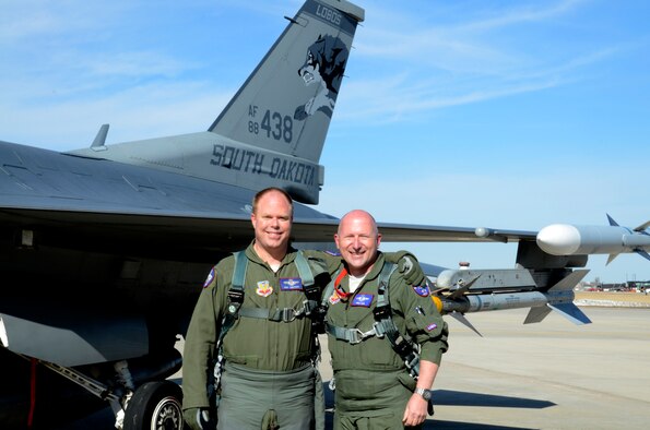 Col. Gregory Lair, right,114th Operations Group commander, and Lt. Col Eric Knutson, 114th Fighter Wing chief of safety, reached a milestone by netting 3,000 career flight hours during a training sortie at Joe Foss Field, S.D., March 11, 2015. The pilots join an elite group of over 260 military pilots that have reached 3,000 flying hours in the F-16 to date. (National Guard photo by Senior Master Sgt. Nancy Ausland/Released)