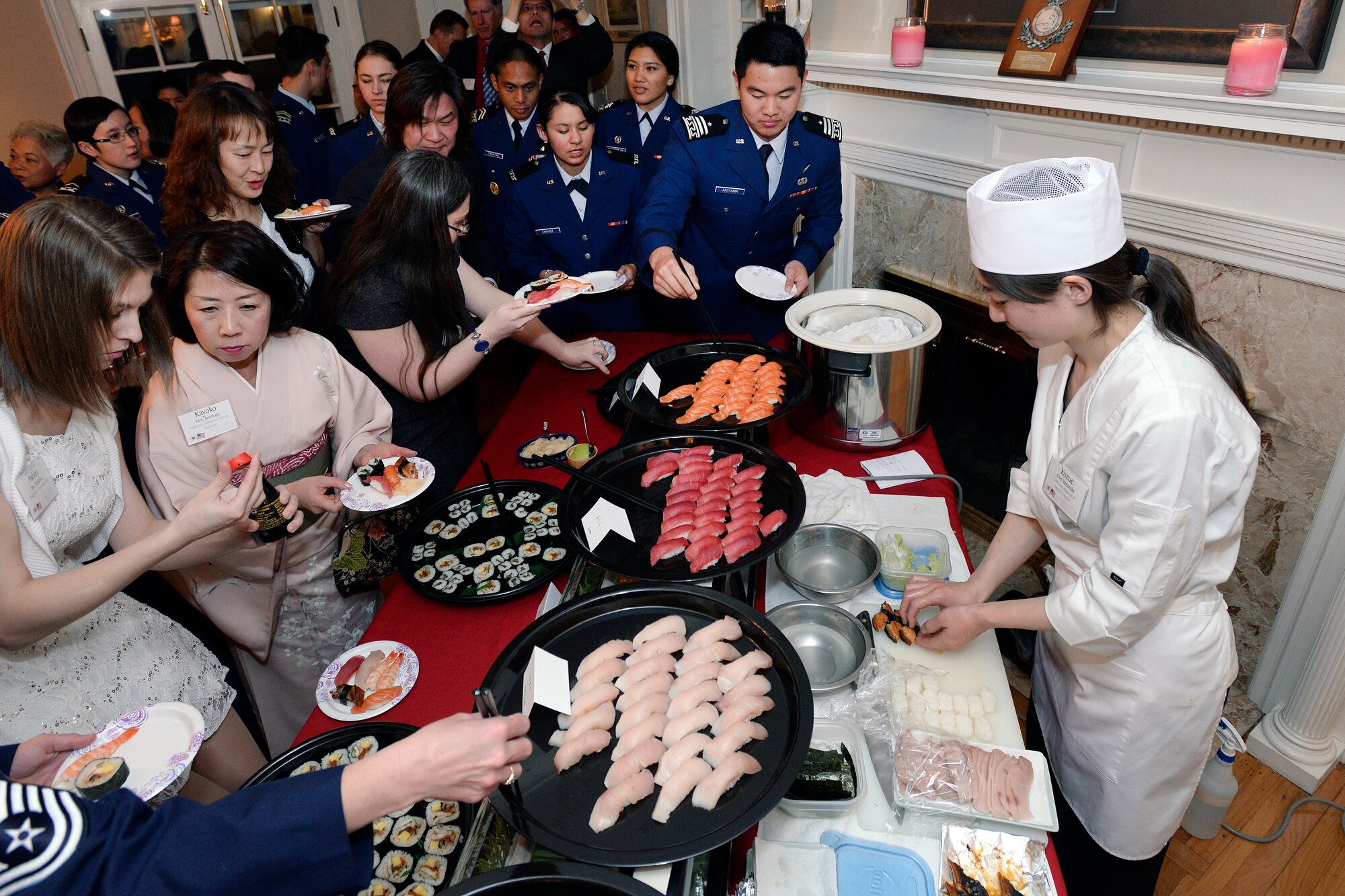 The Consulate-General of Japan in Denver's official cook (right) prepares a meal at the Japanese Tomodachi Dinner here Feb. 24, 2015, hosted by the Academy's commandant of Cadets, Brig. Gen. Stephen Williams and his wife, Holly. 