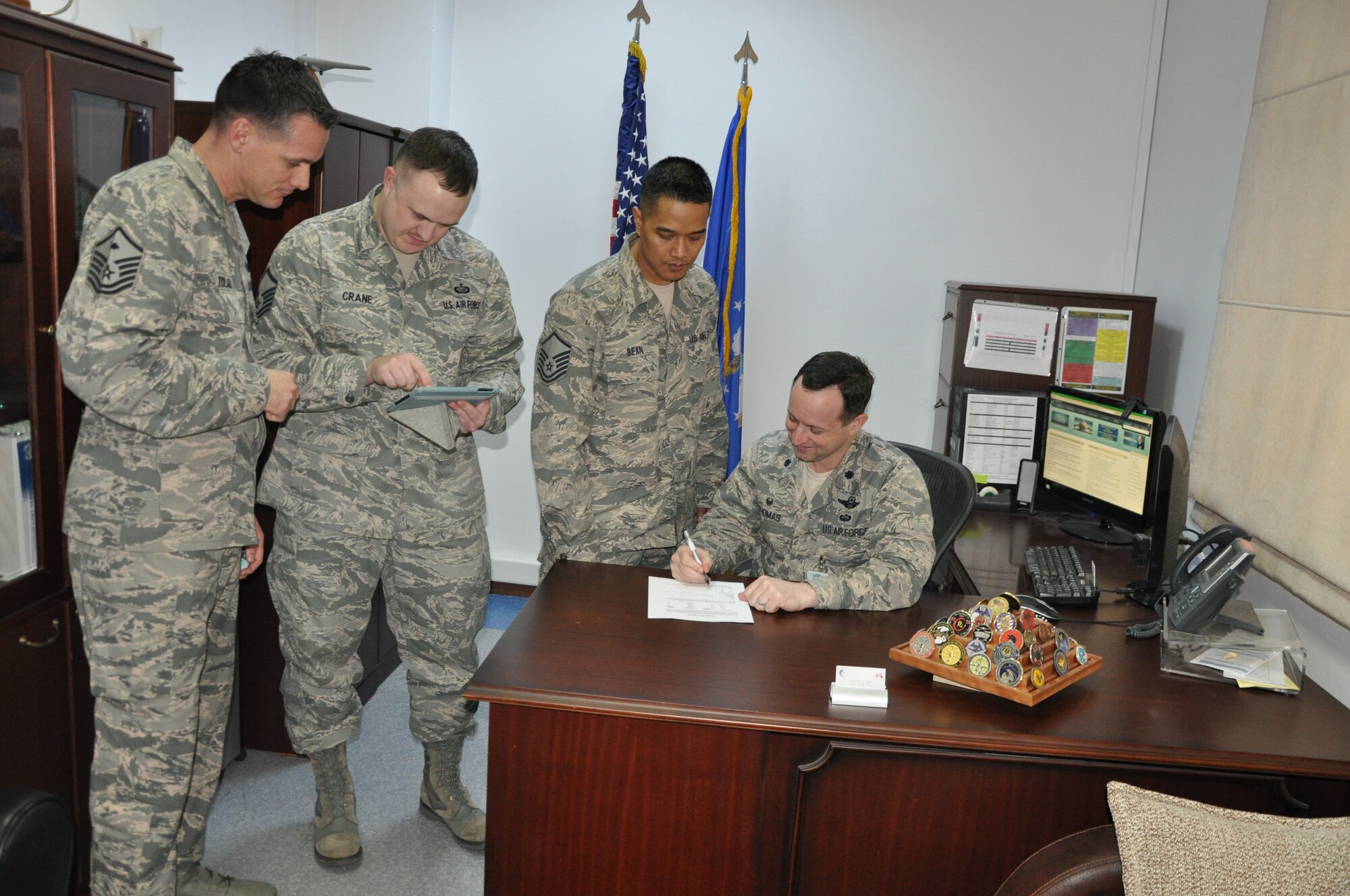 Lt. Col. John Thomas (right), 425th Air Base Squadron commander and senior leaders from the 425th ABS, review Air Force Assistance Fund Campaign details and the AFAF affiliate websites, during preparation for the 2015 AFAF campaign March 9, 2015, Izmir Air Station, Turkey. 
