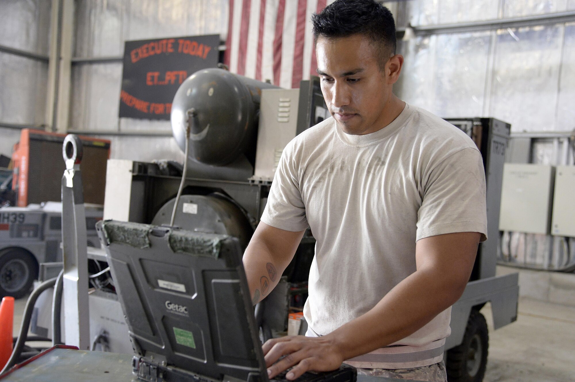 Staff Sgt. Jaime, aerospace ground equipment, prepares his technical order prior to performing a phase 2 inspection on an A/M32A-103 generator March 4 in Southwest Asia. AGE maintains approximately 542 pieces of equipment. Jaime is currently deployed from Tinker Air Force Base and is a native of Oklahoma City. (Air Force photo by Tech. Sgt. Marie Brown)