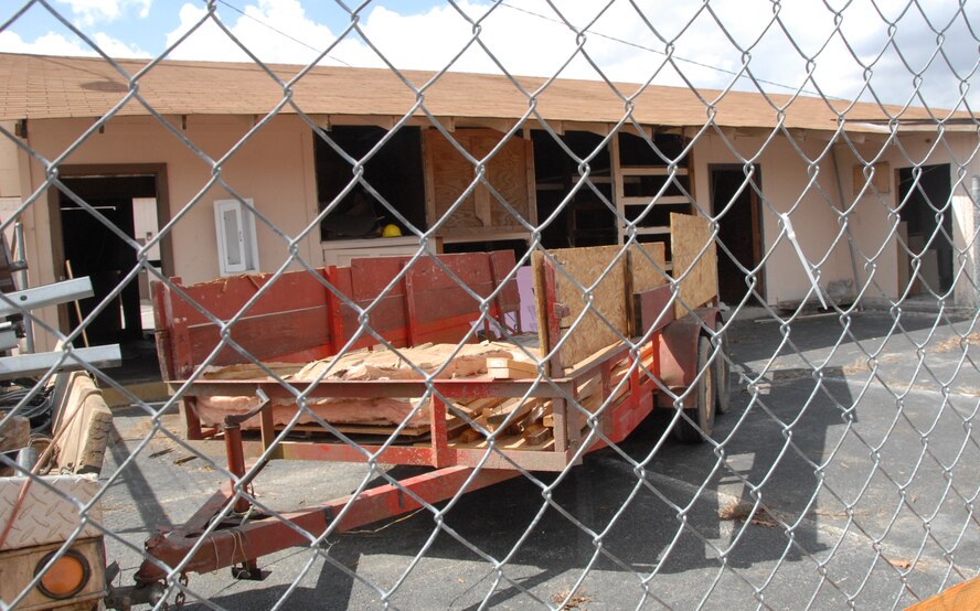 One of the five buildings being removed during the next few weeks sits prepped and  ready for contractors to use a track hoe for its demolition. (U.S. Air Force photo by Misuzu Allen)
