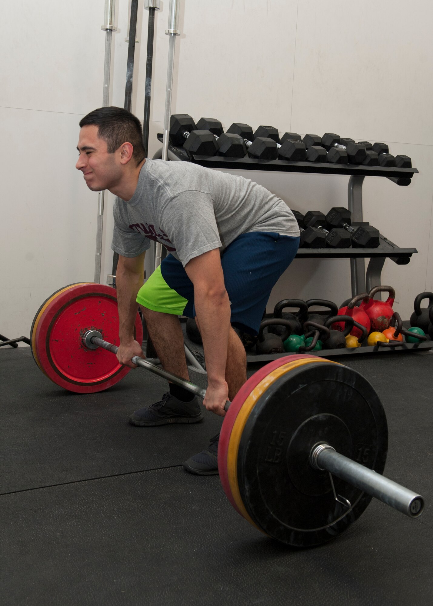 Senior Airman Eugene De Los Santos, 436th Maintenance Squadron crew chief, exercises by performing a deadlift Jan. 30, 2015, at the Fitness Center on Dover Air Force Base, Del. A Common Access Card- reader has been installed at the main entrance to allow customers easy access to the facility after hours. (U.S. Air Force photo/Airman 1st Class Zachary Cacicia)