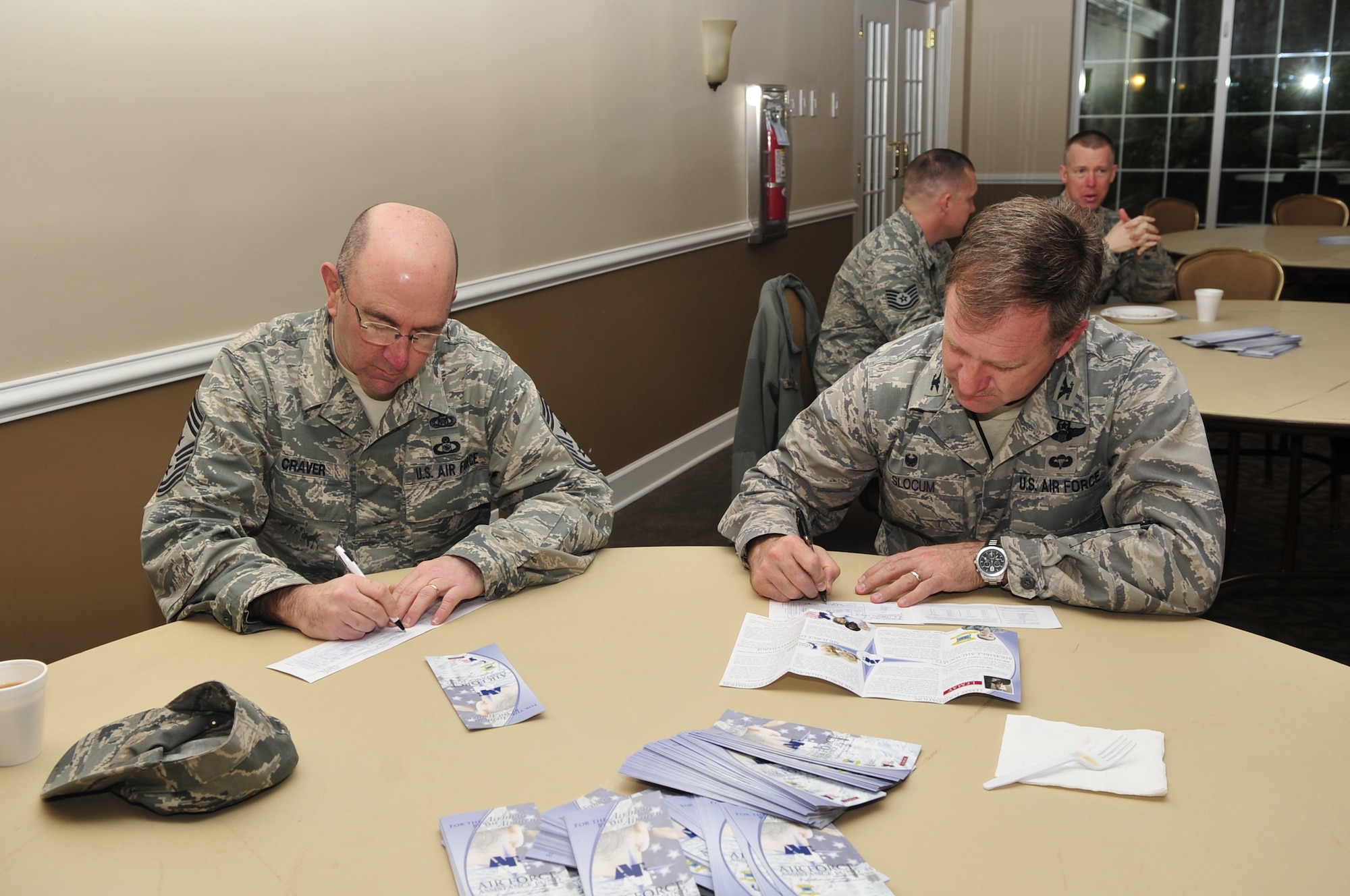 Col. Mark Slocum, 4th Fighter Wing commander, and Chief Master Sgt. Jeffrey Craver, 4th FW command chief, fill out donation cards for the 2015 Air Force Assistance Fund, March 4, 2015, at Seymour Johnson Air Force Base, North Carolina. The AFAF raises funds for a variety of programs that provide support ranging from financial assistance to care for military widows. (U.S. Air Force photo/Airman Shawna L. Keyes)