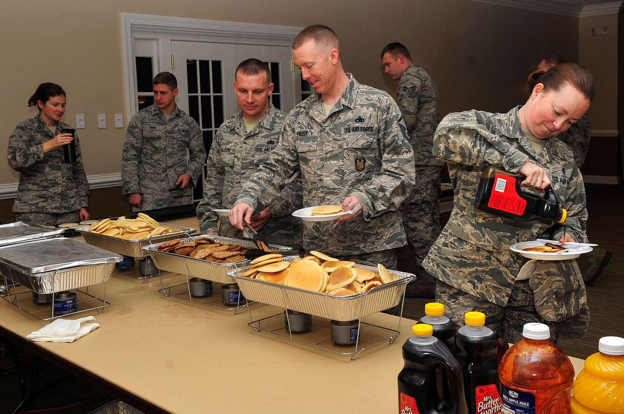 Airmen assigned to the 4th Fighter Wing fill their plates during the 2015 Air Force Assistance Fund kickoff breakfast, March 4, 2015, at Seymour Johnson Air Force Base, North Carolina. The AFAF consists of several charities that provide aid to Airmen including emergency funds, as well as housing and support services for the spouses of fallen Airmen. (U.S. Air Force photo/Airman Shawna L. Keyes)