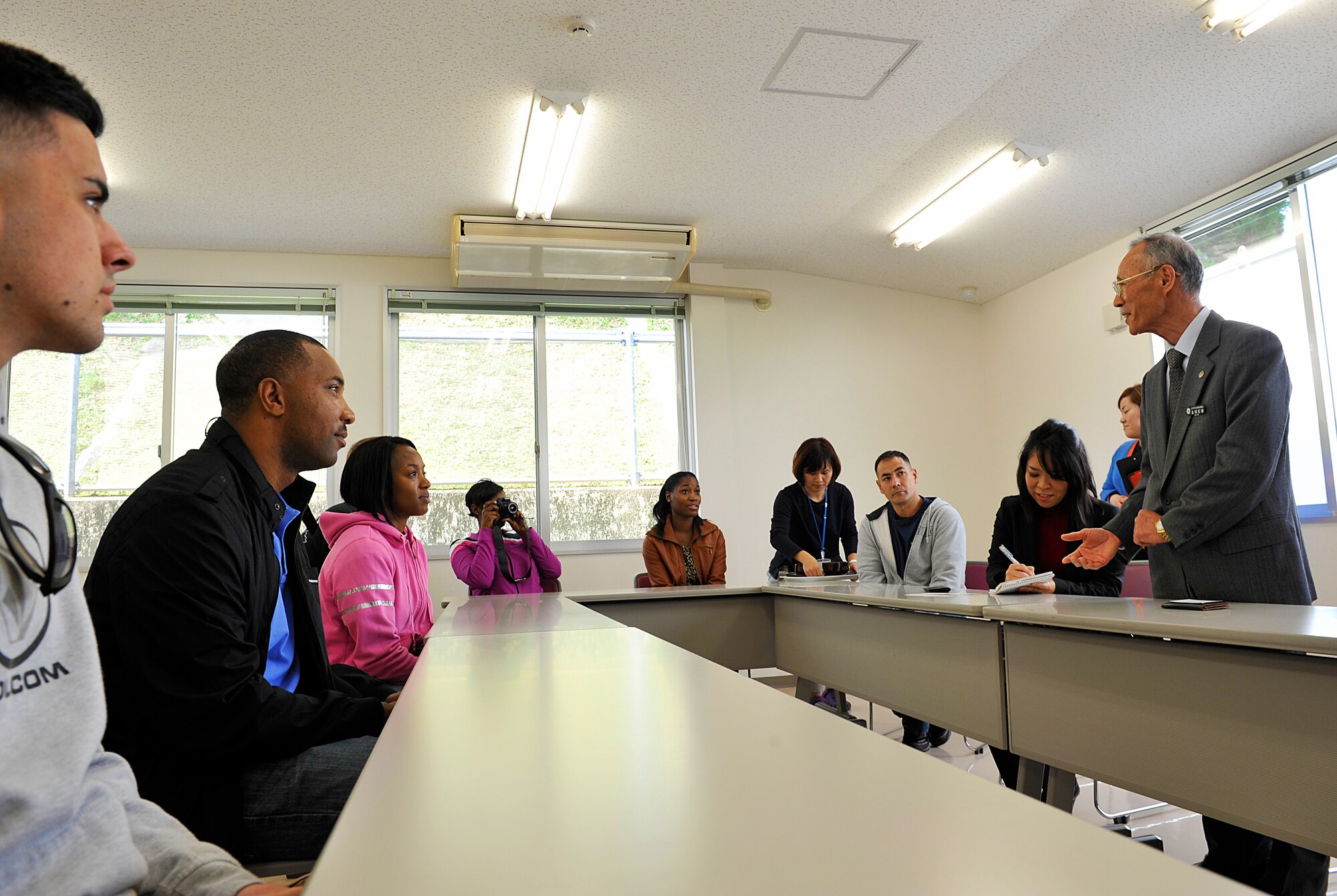 Koutoku Kinjo, Chatan Town Welfare Center chairman, thanks members of Kadena Air Base Top 3 program for volunteering at a food drive event at the Chatan Town Welfare Center, Japan, March 11, 2015. The Okinawa Outreach Committee collected food and toiletry items over the last four months, and delivered the donations to Kadena Town, Okinawa City and Chatan Town welfare centers by members of Kadena's Top 3 program. (U.S. Air Force photo by Naoto Anazawa)


