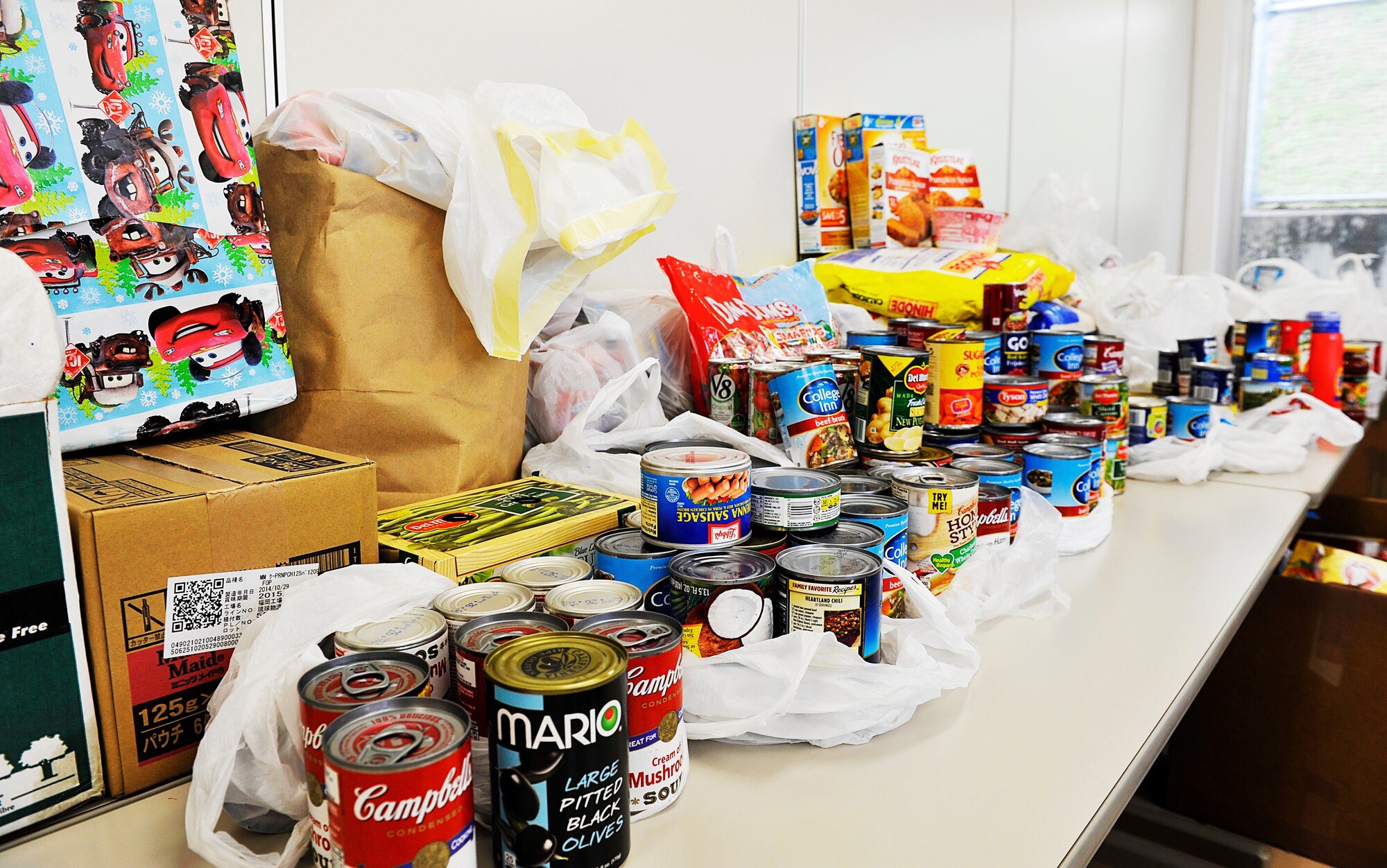 Donations from the Kadena Air Base Top 3 program sit on the table at the Chatan Town Welfare Center, Japan, March 11, 2015. Volunteers from the Kadena Air Base Top 3 program participated in the Okinawa Outreach Committee food drive. They delivered to the Kadena Town and Okinawa City welfare center earlier this year and the Chatan Town welfare center was their third recipient. (U.S. Air Force photo by Naoto Anazawa)