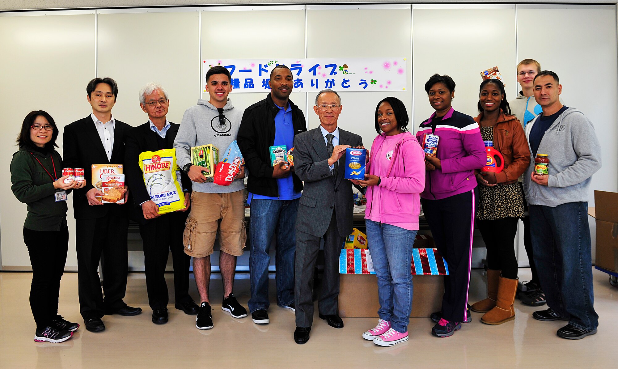 Chatan Town Welfare Center staff and members of Kadena Air Base Top 3 program pose for a group photo at the Chatan Town Welfare Center, Japan, March 11, 2015. The Okinawa Outreach Committee collected approximately 2,000 pounds of food and toiletry donations over the last four months, which was delivered to Kadena Town, Okinawa City and Chatan Town welfare centers by Top 3 members. (U.S. Air Force photo by Naoto Anazawa)