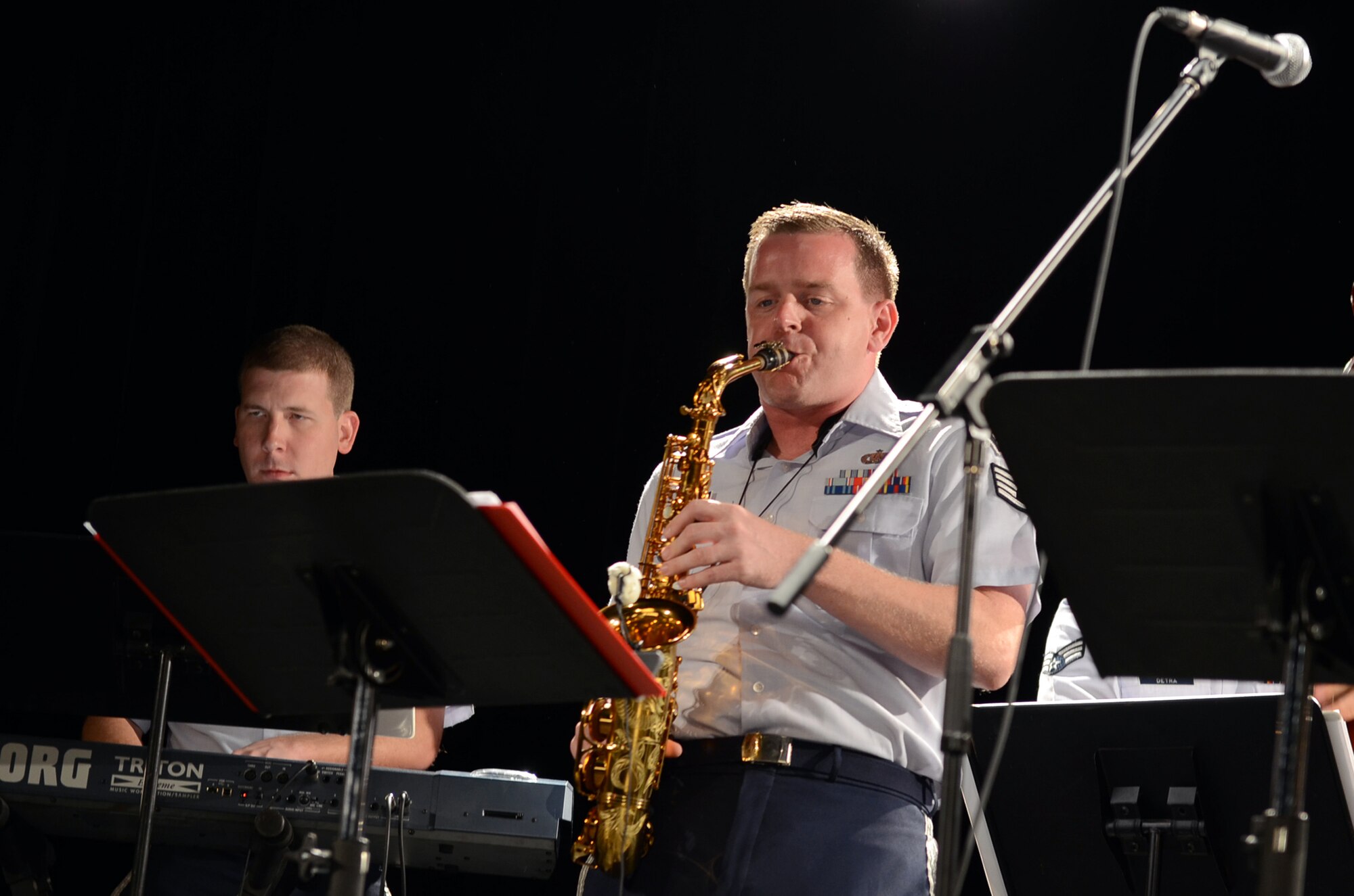 Staff Sgt. Ryan Leatherman, a performer from the Air Force Band of the Pacific’s Papana, plays an alto saxophone solo at a concert at the University of Guam March 11, 2015. The Air Force Band of the Pacific’s Papana supports the U.S. Pacific command strategies of partnership, readiness and presence by conducting protocol, community and nation-building missions throughout the Pacific. (U.S. Air Force photo by Airman First Class Alexa Ann Henderson/Released)