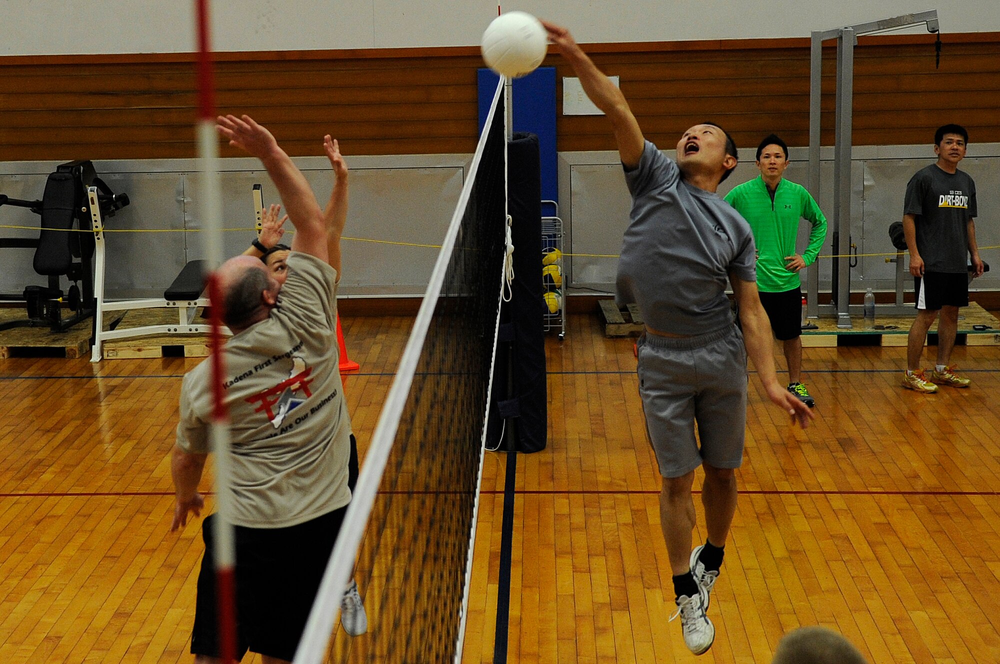 Japan Air Self-Defense Force Tech. Sgt. Daisuke Mitsunaga (right), Iwo To Air Base Group Aerospace Ground Equipment craftsman, spikes a volleyball while U.S. Air Force first sergeants from Kadena Air Base, Japan, attempt to block it during the U.S.-Japan NCO exchange at the Risner Fitness Center, March 12, 2015. The first sergeants competed in multiple games against service members participating in the exchange to strengthen partnerships and create long-lasting relationships with JASDF. (U.S. Air Force photo by Staff Sgt. Marcus Morris)
