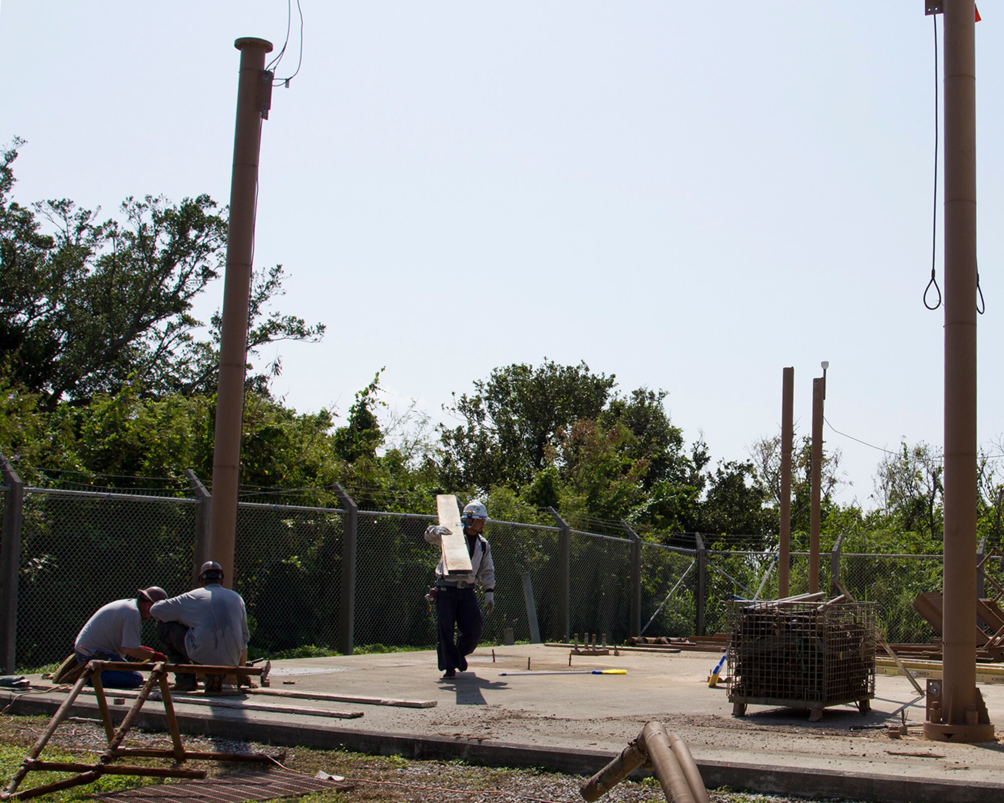 Local Okinawan contractors salvage parts from the Next Generation Weather Radar that was destroyed by typhoon Songda in 2011 near White Beach, Japan, March 1, 2014. The new tower is estimated to be completed by April 27, 2015, and will give advanced typhoon and thunderstorm warnings. (Courtesy photo by Andrew Fletcher)