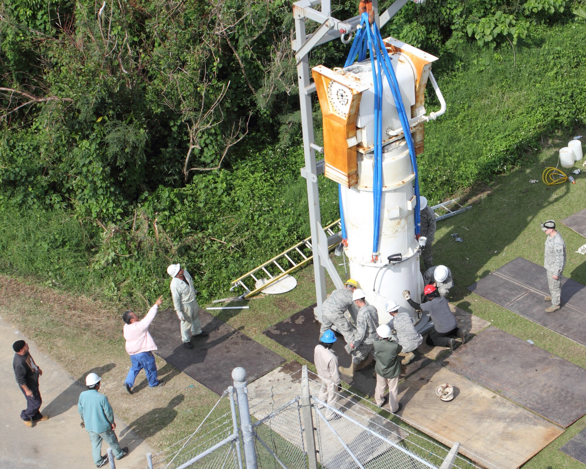 Airmen from the 18th Communications Squadron and local contractors salvage parts from the Next Generation Weather Radar that was destroyed by typhoon Songda in 2011 near White Beach, Japan, Dec. 12, 2012. Following the destruction, White Beach local officials and 18th Wing leadership decided that the NEXRAD would be moved to an abandoned Boy Scout camp, secluded in the woods 1,200 feet away from local residents. (Courtesy photo by Andrew Fletcher)