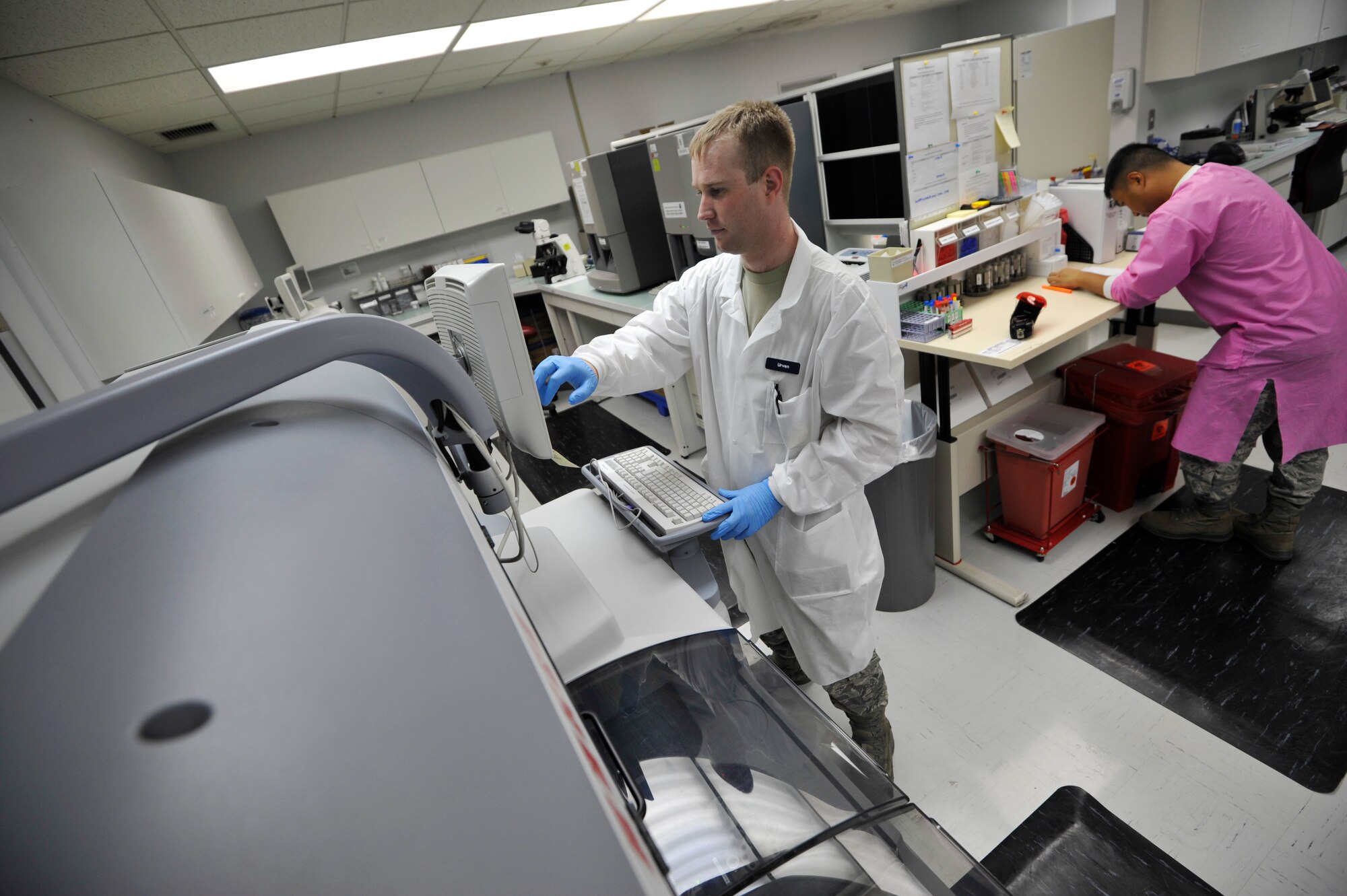 U.S. Air Force Senior Airman Rion Urven, 35th Medical Support Squadron medical lab technician, and  Staff Sgt. John-Andre Obedoza, 35 MDSS NCO in charge of shipping and urinalysis, are assigned to the 35th Medical Group’s laboratory flight and are tasked with providing accurate diagnostic support at Misawa Air Base, Japan, March 11, 2015. Lab technicians work in different sections inside the laboratory including hematology, chemistry, microbiology, urinalysis, and shipping, among other divisions. (U.S. Air Force photo by Senior Airman Jose L. Hernandez-Domitilo/Released)