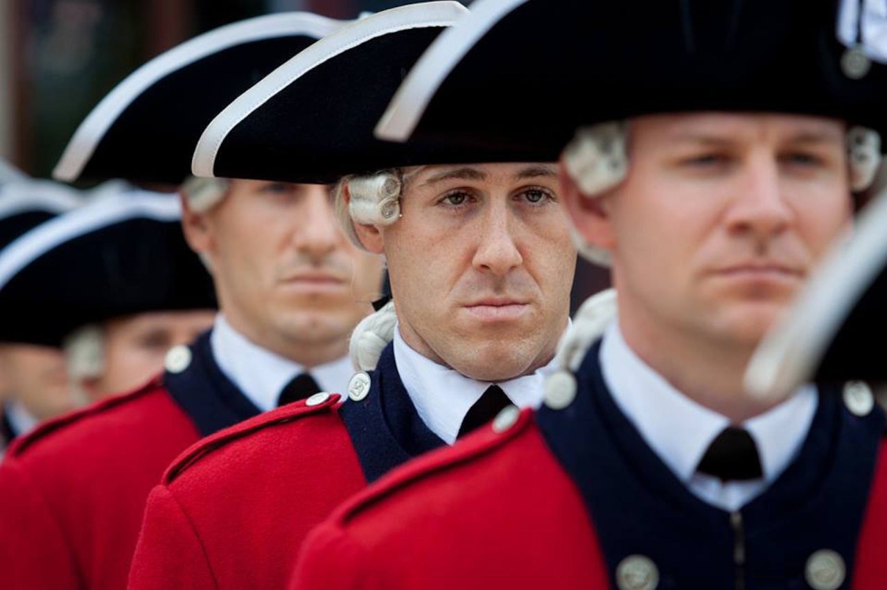 Army Staff Sgt. William J. Parks, center, a musician with the 3rd U.S. Infantry Regiment’s Old Guard Fife and Drum Corps, stands at attention during a performance. Parks became the first corps musician in recent years to complete the U.S. Army's Air Assault Course at Fort Benning, Ga. U.S. Army photo by Sgt. 1st Class Richard Ruddle