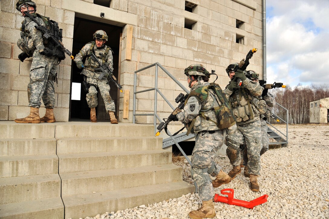 U.S. soldiers exit a building after searching and clearing all the rooms during a senior leaders urban assault training in Grafenwoehr, Germany, March 5, 2015.