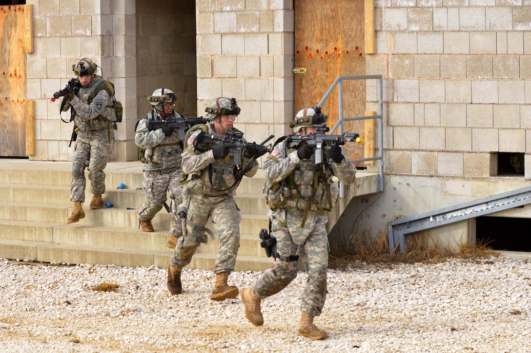 U.S. soldiers rush to the next objective after clearing a building ...