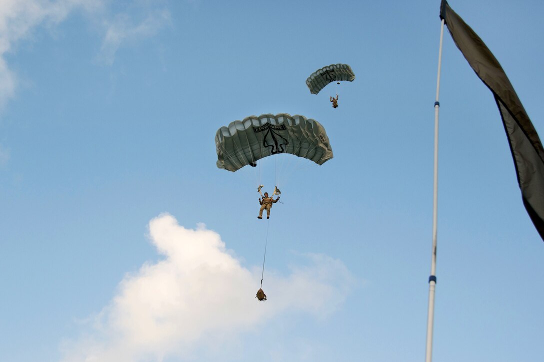 Army paratroopers participate in a combat equipment jump demonstration on Homestead Air Reserve Base, Fla., March 4, 2015. The paratroopers are assigned to the U.S. Army Special Operations Command parachute team, the Black Daggers, based at Fort Bragg, N.C. They were conducting preseason demonstration training.