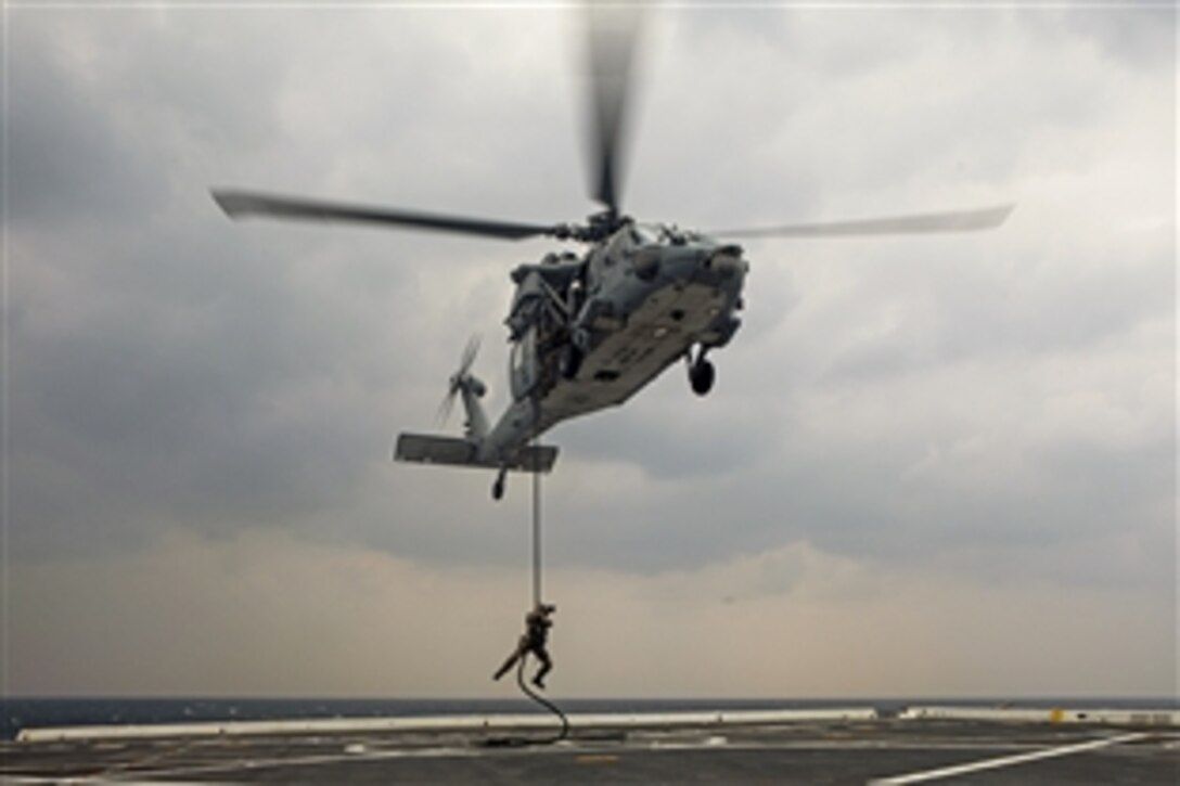 U.S. Marines conduct a fast rope exercise as part of amphibious integration training aboard the USS Green Bay in the East China Sea, March 10, 2015. The Marines are assigned to the 31st Marine Expeditionary Unit. 