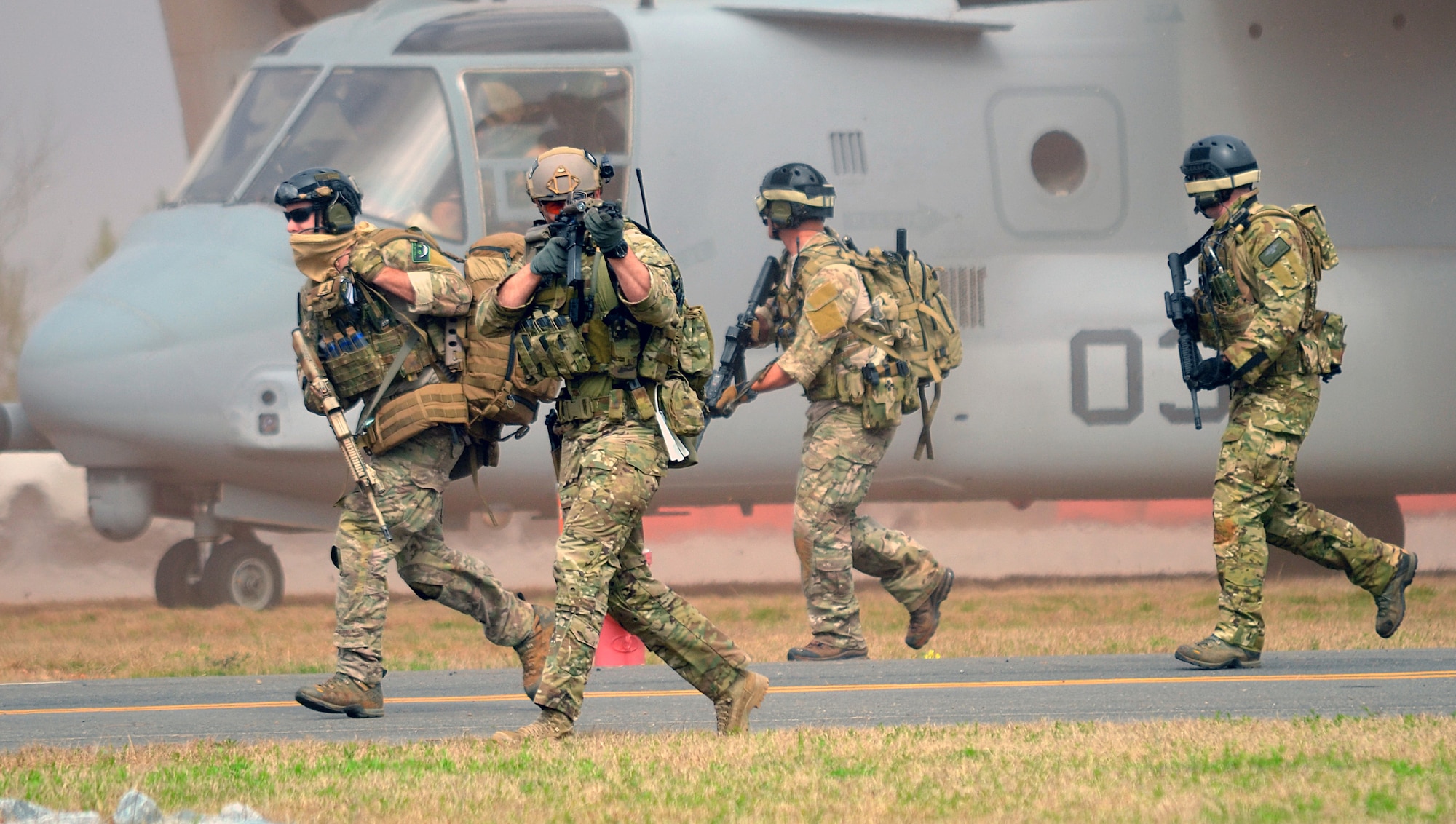 Pararescue Jumpers and Combat Rescue Officers, 920th Rescue Wing, Patrick AFB, FL, conduct joint training with a Marine Osprey tilt-rotor aircraft at the Guardian Center training facility March 11, 2015 in Perry, GA. This four-day exercise used HH-60 Pave Hawks and MV-22 Ospreys for simulated scenarios that included earthquake collapsed buildings, vehicle-borne improved explosive devices detonating, and mass casualty response. (U.S. Air Force photo/Staff Sgt. Kelly Goonan)