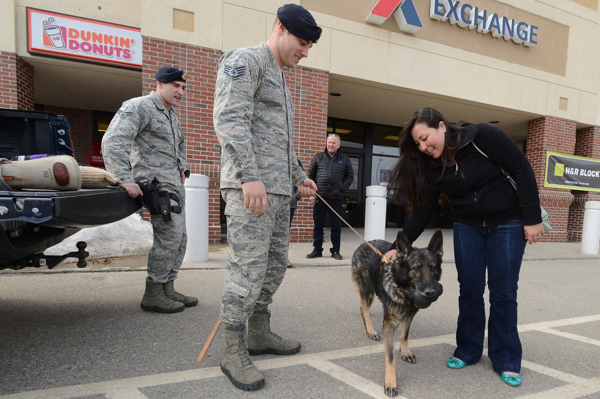 Military Working Dog Csuma along with his 66th Security Forces Squadron Handler Staff Sgt. Charles Cornacchio participate in a Military Working Dog Appreciation Day display at the Base Exchange March 13. MWDs are used in patrol, drug and explosive detection and specialized mission functions for the Department of Defense and other government agencies. (U.S. Air Force photo by Jerry Saslav) 
