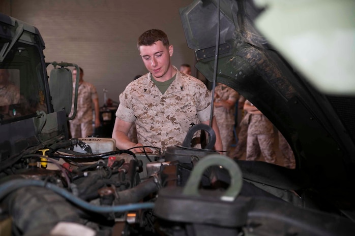 Cpl. Connor G. Reap inspects the final bolt put in a Humvee that made Marine Air Control Squadron 4 100% equipment ready March 13 on Marine Corps Air Station Futenma. “Marine Corps wide no one is at 100% readiness, except us right now,” said Reap. “There are some Marines who have been in for 20 plus years and they didn’t believe it. It made me feel like a rock star to know that we are the only unit in the Marine Corps to be 100% ready.” Reap, from Wanaque, New Jersey, is a quality control non-commissioned officer with MACS-4, Marine Air Control Group 18, 1st Marine Aircraft Wing, III Marine Expeditionary Force. 