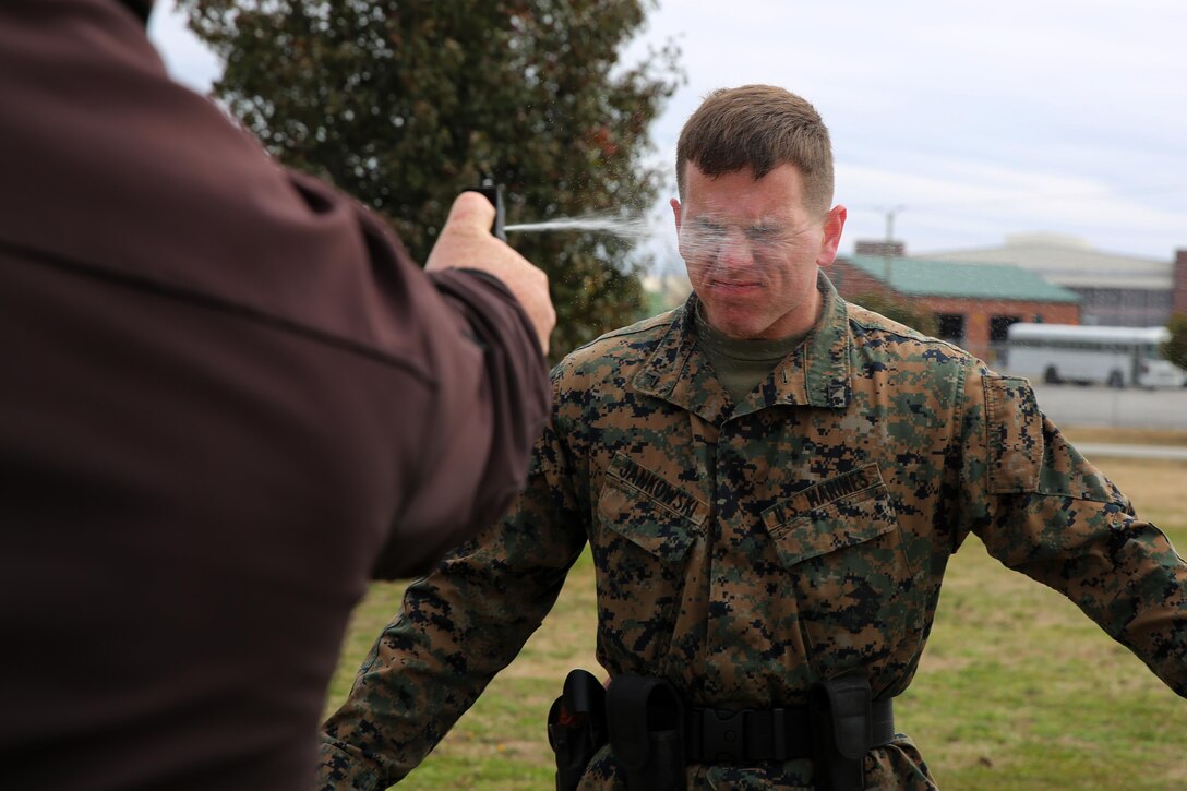 Lance Cpl. Dakota Jankowski gets sprayed with Oleoresin Capsicum, a potent pepper spray-like chemical during an obstacle course at Marine Corps Air Station Cherry Point, N.C, March 6, 2015. Marines with the Provost Marshal’s Office must complete the obstacle course while under the effects of OC spray in order to pass the exercise. Jenkish is a student in the block training course for PMO guards and a native of Camano Isle, Wash.