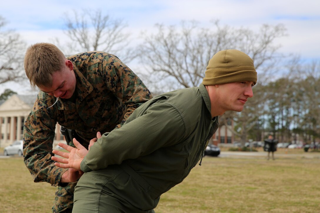 Lance Cpl. Christopher Duffy handcuffs Cpl. Scott Wareham after being sprayed with Oleoresin Capsicum, a potent pepper spray-like chemical at Marine Corps Air Station Cherry Point, N.C, March 6, 2015. Marines with the Provost Marshal’s Office must complete the exercise while under the effects of OC spray in order to pass the Block training course. Duffy is a student with PMO, and is a native of Ashlyn, Ohio; Wareham is a military policeman and a native of Delanco, N.J., both with Headquarters and Headquarters Squadron.


