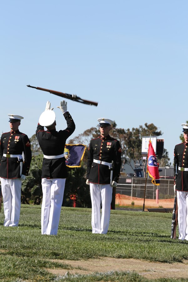 A Marine reaches to catch a rifle during a Battle Colors Ceremony aboard Marine Corps Air Station Miramar, Calif., March 13. The Battle Colors Ceremony consists of a performance by the Silent Drill Platoon and “the Commandant’s Own” Drum and Bugle Corps.