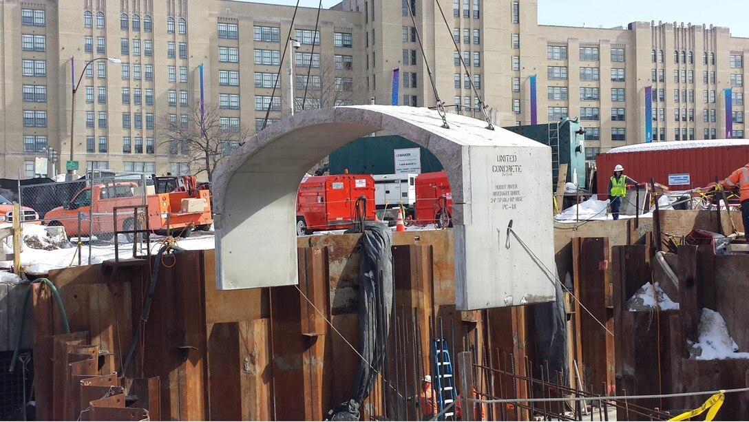Precast concrete culvert section being lowered into position onto the concrete pile caps as part of the Muddy River Flood Risk Management project, Boston, Massachusetts.