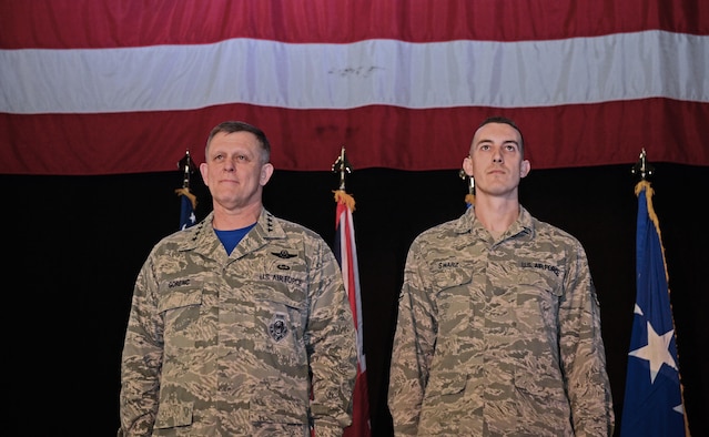Gen. Frank Gorenc (left) and Staff Sgt. Greggory Swarz stand at attention during an Airman’s Medal presentation March 13, 2015, at Royal Air Force Lakenheath, England. Swarz was recognized for his heroic actions on Jan. 26, 2015, when he saved the lives of three French airmen after a Hellenic air force F-16 Fighting Falcon crashed into the parking ramp at Los Llanos Air Base, Spain, during Tactical Leadership Program 15-1. Gorenc is the U.S. Air Forces in Europe and Air Forces Africa commander and Swarz is a 492nd Aircraft Maintenance Unit electrical environmental systems specialist. (U.S. Air Force photo/Airman 1st Class Dawn Weber) 