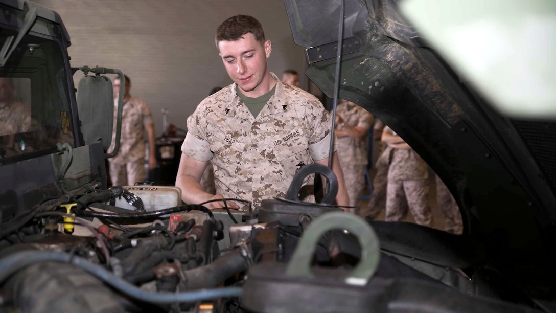 Cpl. Connor G. Reap inspects the final bolt put in a Humvee that made Marine Air Control Squadron 4 100-percent equipment ready March 13 on Marine Corps Air Station Futenma. “Marine Corps wide no one is at 100 percent readiness, except us right now,” said Reap. “There are some Marines who have been in for 20 plus years and they didn’t believe it. It made me feel like a rock star to know that we are the only unit in the Marine Corps to be 100 percent ready.” Reap, from Wanaque, New Jersey, is a quality control non-commissioned officer with MACS-4, Marine Air Control Group 18, 1st Marine Aircraft Wing, III Marine Expeditionary Force.