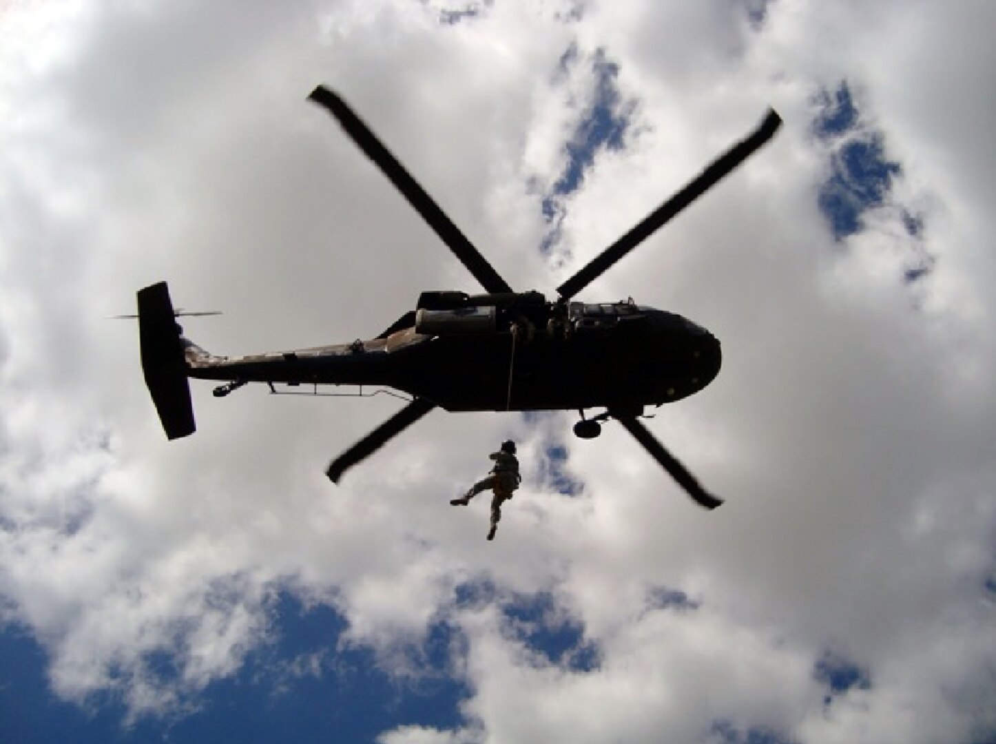 Staff Sgt. Chuck Call, of Company C, 1st Battalion, 106th Assault Helicopter Battalion, of Fort Leonard Wood, hangs from a UH-60 Black Hawk hoist during training in Springfield.