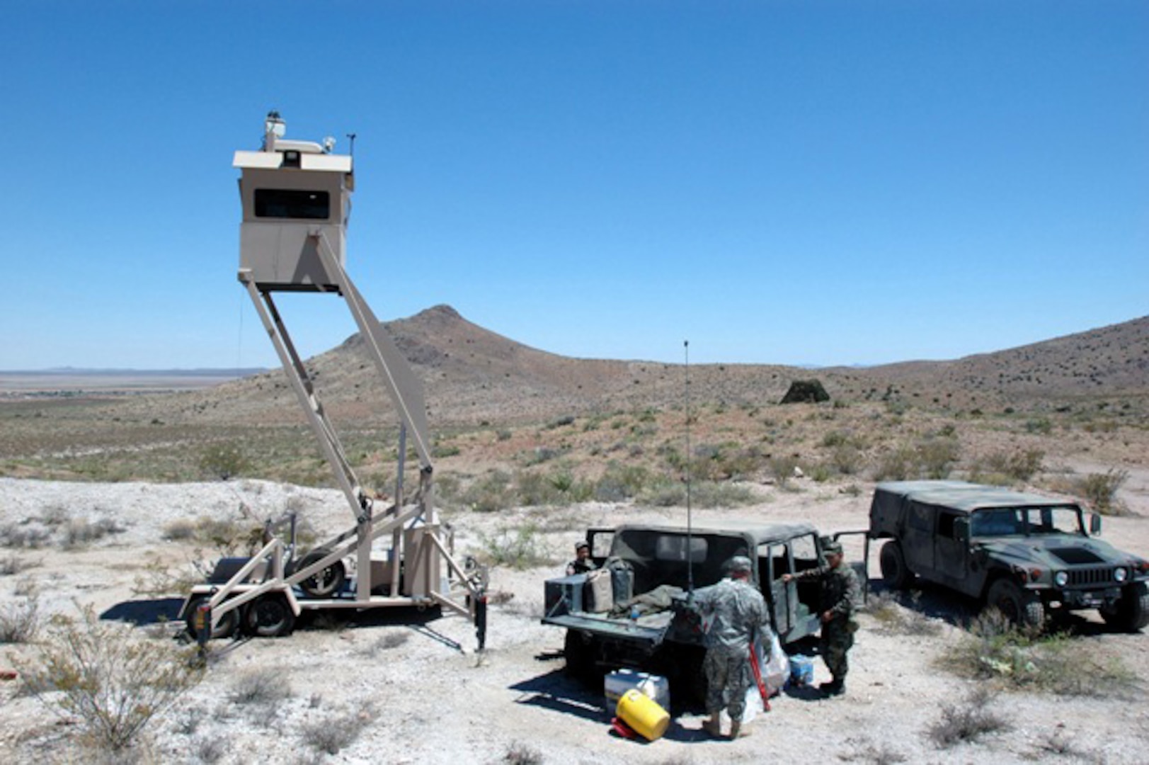 An entry identification team consisting of U.S. Army Soldiers from the National Guard man a post on Johnson Mountain in New Mexico June 17, 2006. The team gathers intelligence about illegal immigrants attempting to enter the U.S. from Mexico and relays it to Border Patrol agents.