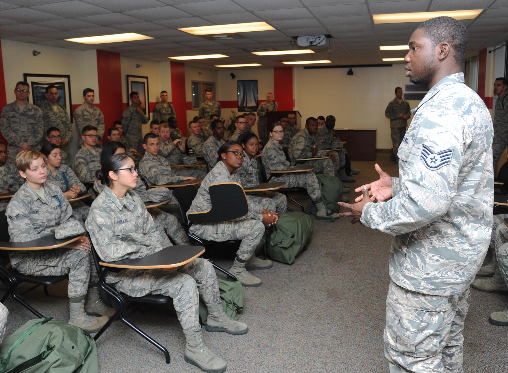 Staff Sgt. Deltron McRae, 81st Force Support Squadron career development technician, speaks to 335th Training Squadron Airmen about the importance of the mobility processing line during an “Introduction to Mobility” training day for non-prior service Airmen at Davis Manor, Keesler Air Force Base, Mississippi, March 13, 2015. Airmen participated in pre-deployment training scenarios such as: going through a mobility processing line, administering self-aid and buddy care, reviewing the steps for wearing chemical warfare gear and receiving a pre-deployment briefing. The training was conducted to better prepare Keesler’s Airmen for deployment operations. (U.S. Air Force photo by Kemberly Groue)