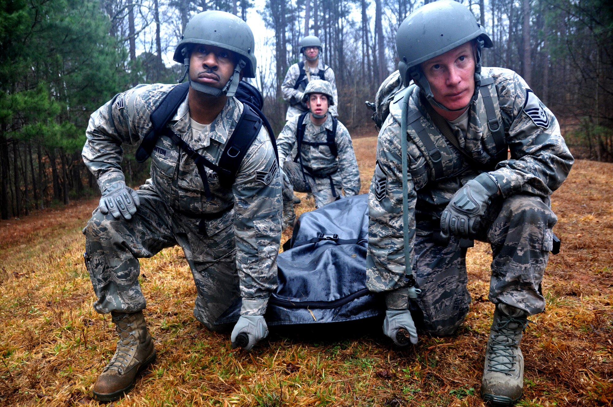 Airman from the 911th Force Support Squadron, Pittsburgh, Pa., prepare to carry a casualty dummy during a Silver Flag exercise March, 10, 2015, at Dobbins Air Reserve Base, Ga. Services Airmen from six different installations across Air Force Reserve Command participated in the Silver Flag training exercises at Dobbins. (U.S. Air Force photo/Senior Airman Daniel Phelps/Released)