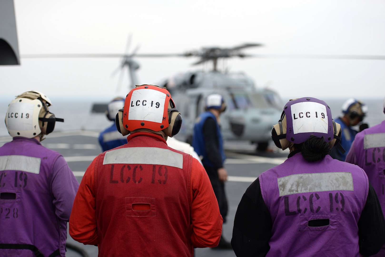 YOKOSUKA, Japan (March 14, 2015) Sailors from the damage control and refueling teams aboard the the U.S. 7th Fleet flagship USS Blue Ridge (LCC 19) observe an MH-60S Seahawk from Helicopter Sea Combat Squadron (HSC) 12 during flight operations. Blue Ridge resumed patrols to engage with regional partners throughout the U.S. 7th Fleet area of operations following a six-month ships restricted availability period. (U.S. Navy photo by Mass Communication Specialist 3rd Class Samuel Weldin/ RELEASED)