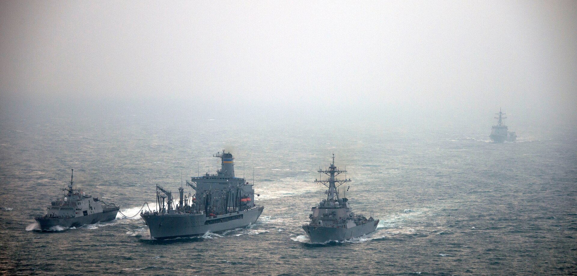 WATERS TO THE WEST OF THE KOREAN PENINSULA (March 9, 2015) The littoral combat ship USS Fort Worth (LCS 3) and the guided-missile destroyer USS John S. McCain (DDG 56) conduct a replenishment-at-sea from the Military Sealift Command fleet replenishment oiler USNS Pecos (T-AO 197) during exercise Foal Eagle 2015. Foal Eagle is a series of annual training events that are defense-oriented and designed to increase readiness and maintain stability on the Korean Peninsula while strengthening the Republic of Korea-U.S. alliance and promoting regional peace and stability of the Indo-Asia-Pacific region. (U.S. Navy photo by Mass Communication Specialist 2nd Class Daniel M. Young/Released)