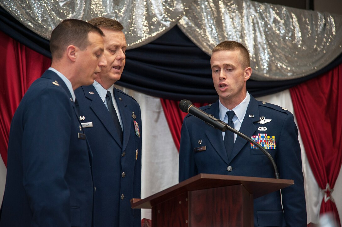 Col. Timothy MacGregor, 47th Operations Group commander, center, Lt. Col. Brian Pardee, 47th Operations Support Squadron commander, left, and Lt. Col. Randy Oakland, 87th Flying Training Squadron commander, sing the national anthem at the Del Rio Annual Awards Banquet in Del Rio Texas, March 12, 2015. The trio helped kick off the annual award banquet put on by the Del Rio Chamber of Commerce that highlights Laughlin’s and the chamber’s annual award winners. (U.S. Air Force photo by Staff Sgt. Nathan Maysonet)(Released)   