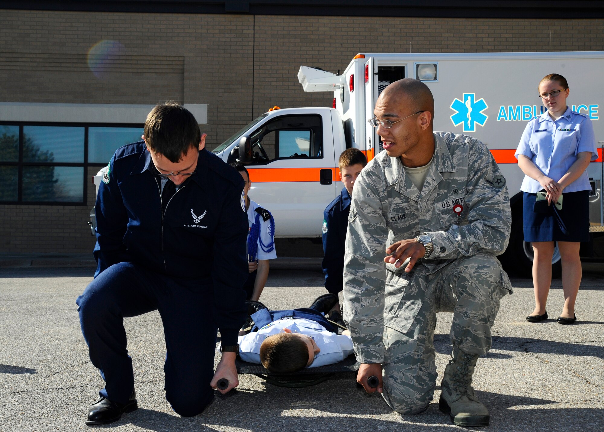 Airman Gilbert Clark, 22nd Aerospace Medicine Squadron medical technician, shows a group of Derby High School Junior ROTC cadets how to carry a litter, March 11, 2015, at McConnell Air Force Base, Kan. Clark was one of several Airmen to show cadets from local schools what the Air Force medical career field is like during a base tour. (U.S. Air Force photo by Senior Airman Victor J. Caputo)