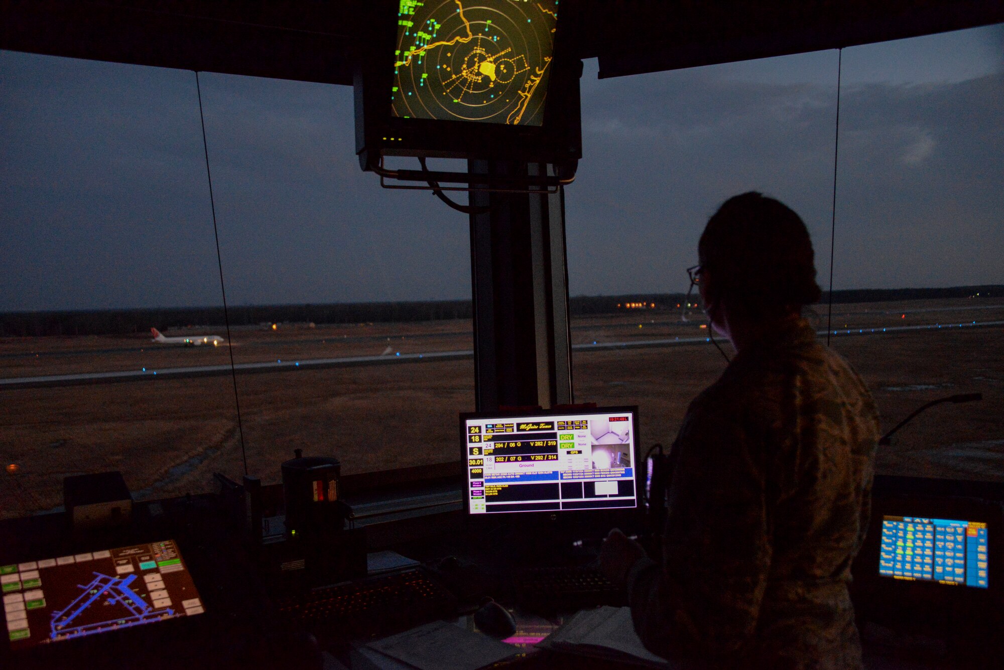 Senior Airman Katlyn Herndon, 305th Operations Support Squadron air traffic controller, instructs a commercial aircraft where it will park on McGuire Airfield at Joint Base McGuire-Dix-Lakehurst, N.J., March 11, 2015. Controllers maintain a 24/7 mission to ensure no mishaps occur over JB MDL airspace. (U.S. Air Force photo by Airman 1st Class Tara A. Williamson/Released)